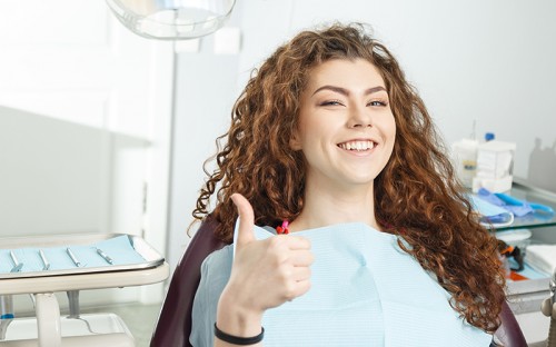 Girl with thumbs up in dental office